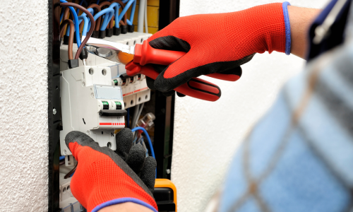 An electrician installing an outlet